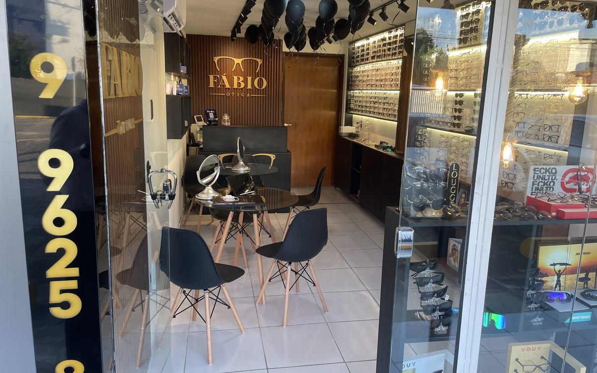 Entrada da loja com portas de vidro e iluminação acolhedora